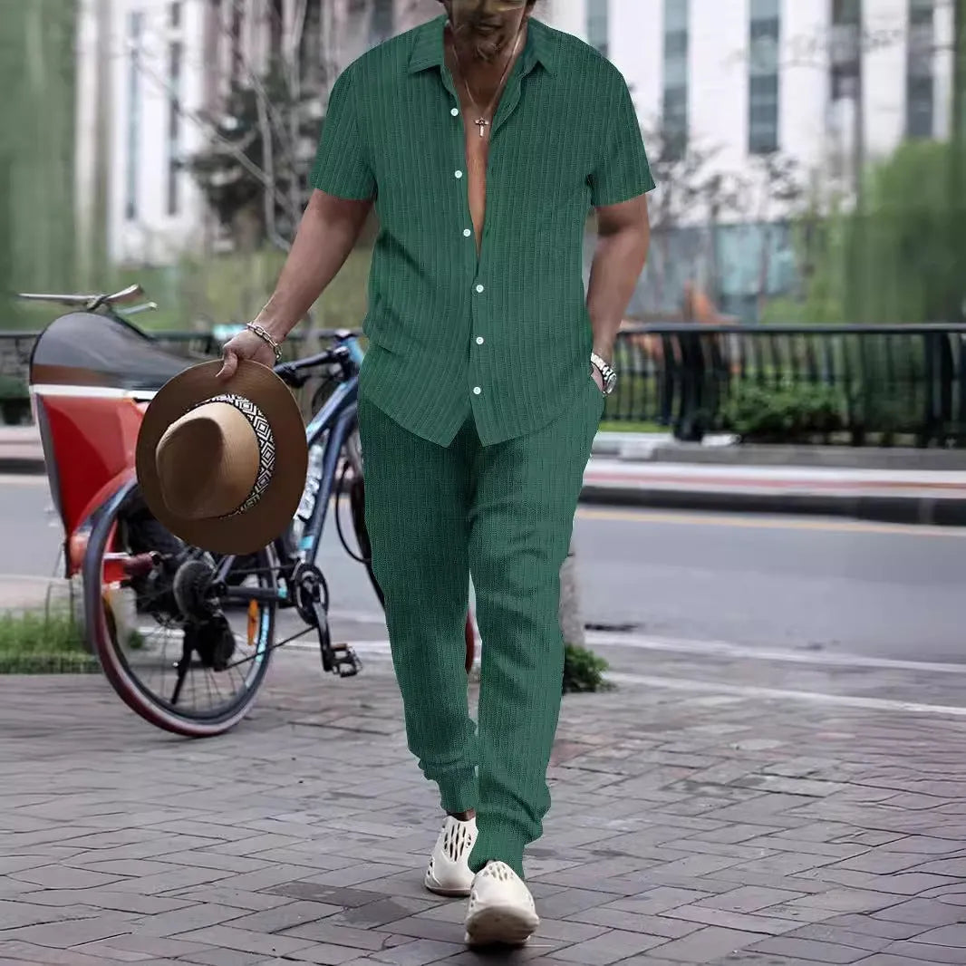 Man wearing a casual short-sleeve shirt and trousers beach suit set in a light blue colour.