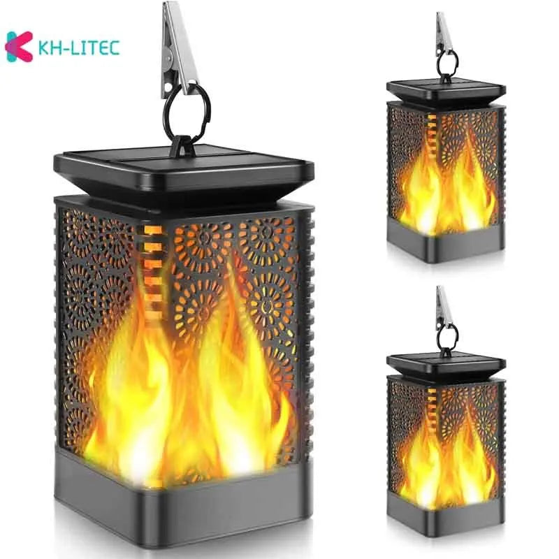 Set of four black solar-powered garden lanterns with flickering flame LED lights.