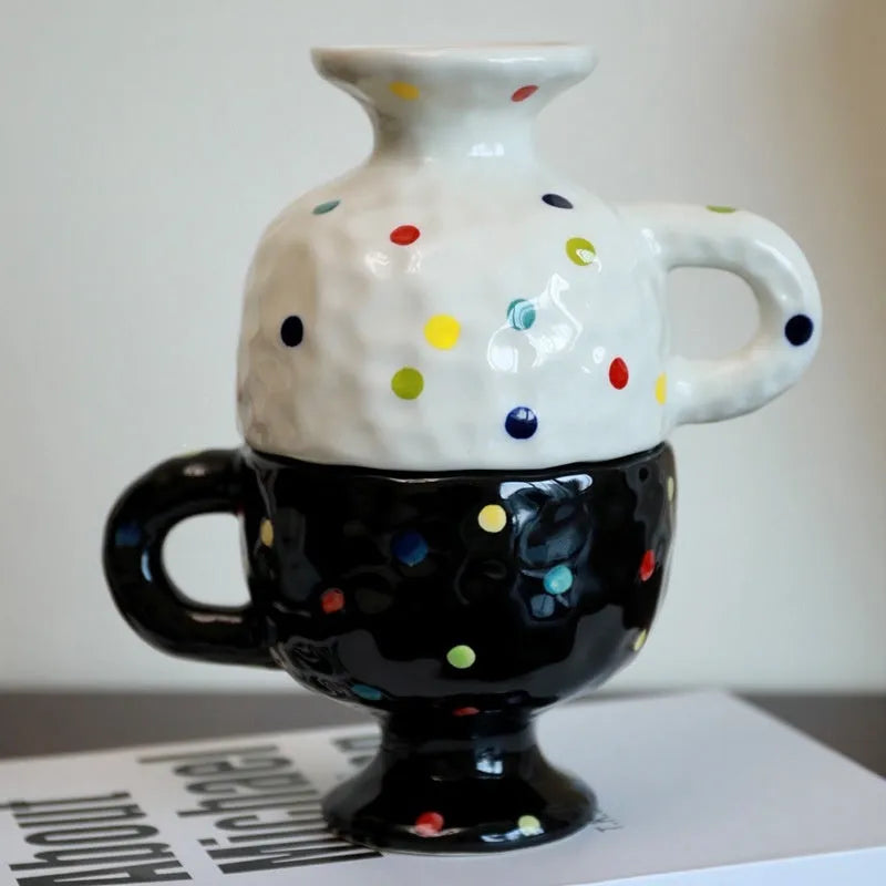 Irregularly shaped hand-pinched ceramic mug in a solid colour, shown on a plain background.