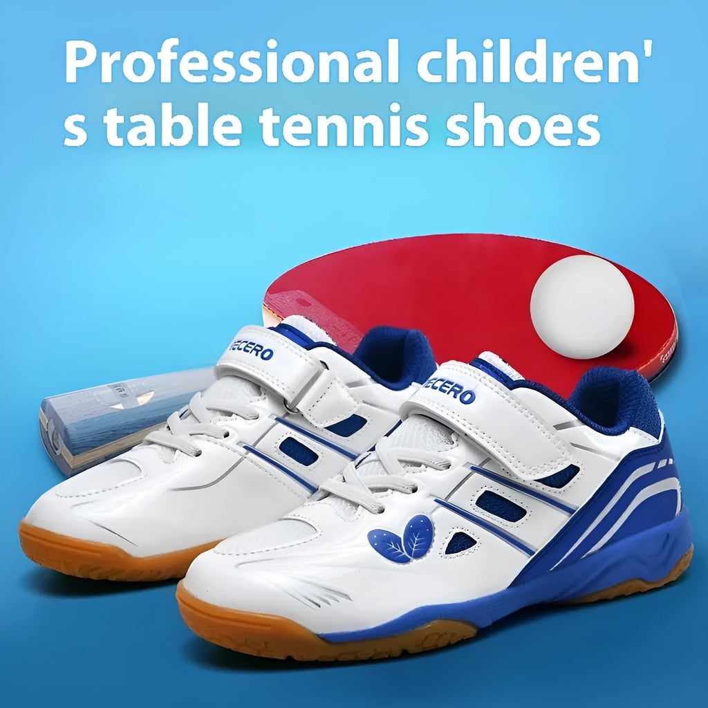 Low-top white and blue badminton shoes with a ribbed sole on a hard court surface.