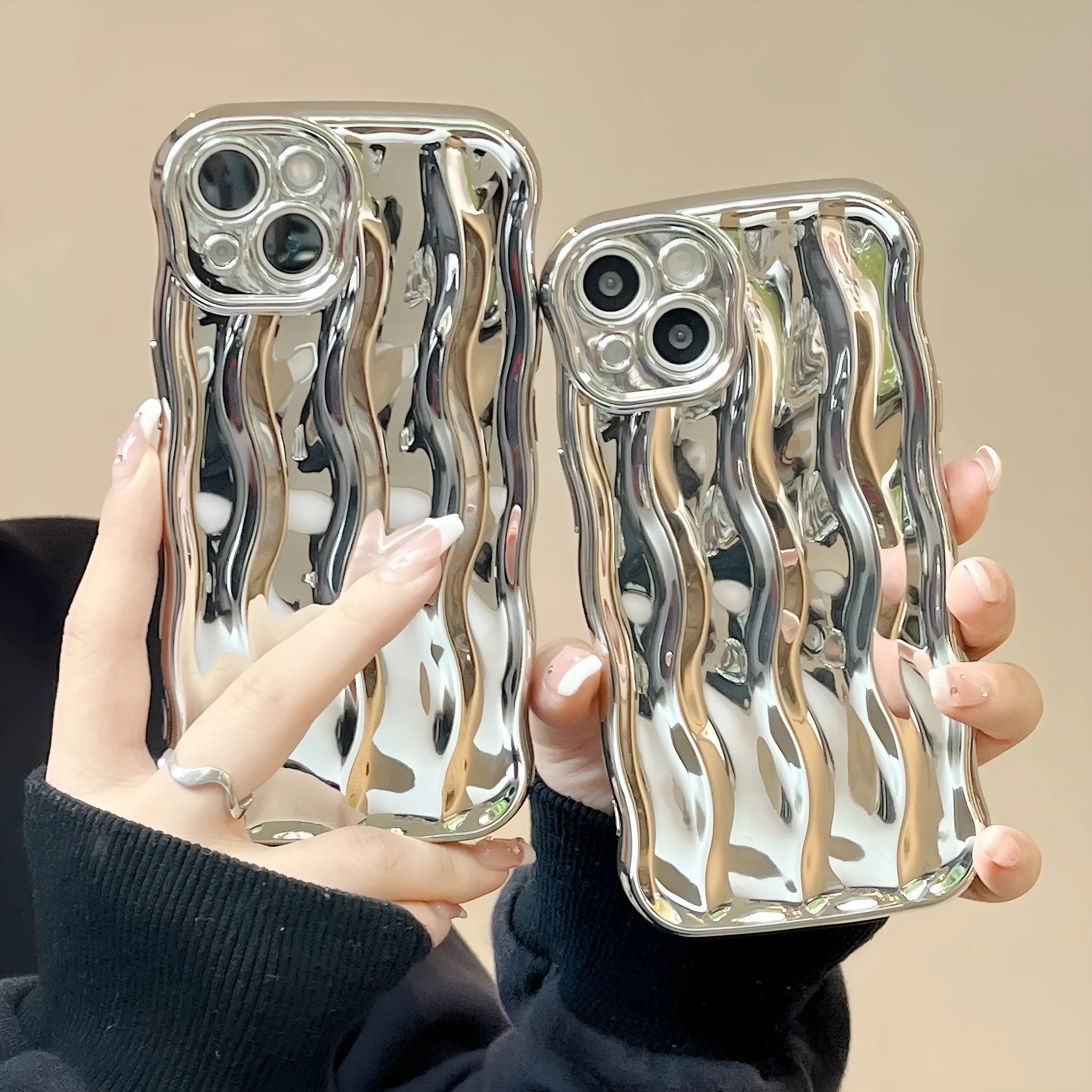 iPhone 17 Pro Max phone case with electroplated silver wave stripe design on black TPU back cover.