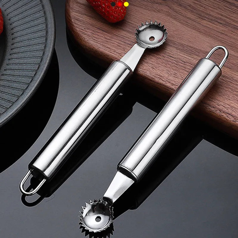 Stainless steel strawberry stem remover on a kitchen counter, modern minimalist design for coring fruit