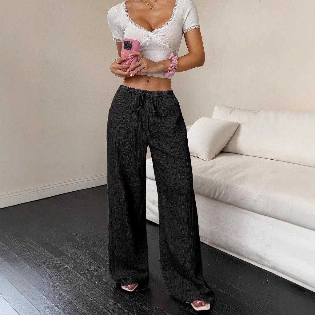 Women's black wide-leg trousers with a front lace-up detail on the mid-rise waistband.