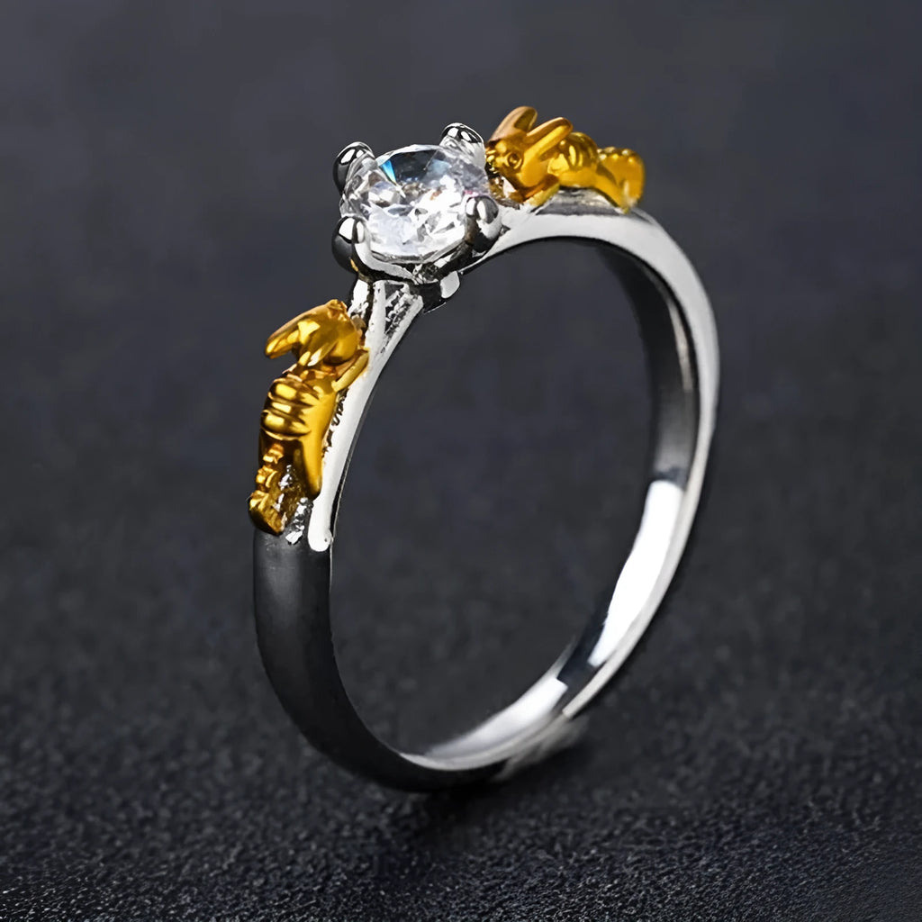 Close-up of a black gold plated crown ring on a finger, showing detailed copper modelling and a dark metallic finish.
