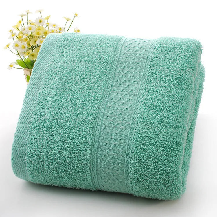 Thick bath and beach towels in seven colour options including apple green, dark blue, and light pink