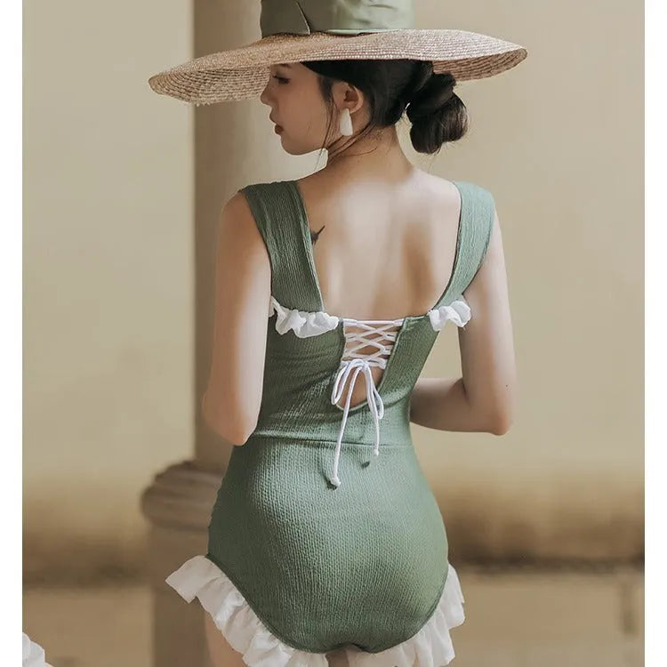 Korean-style high-waist one-piece swimsuit in black, pink, or green on a model
