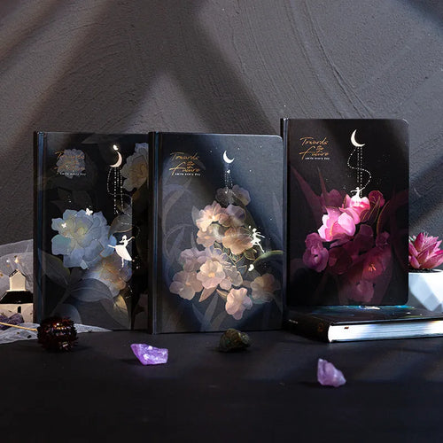 A5 notebook with luminous cover open to show pages filled with colour illustrations.