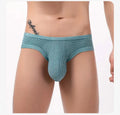 Men's low waist cotton briefs with hollow back design in red, black, blue, white, light green, grey red, or pink.