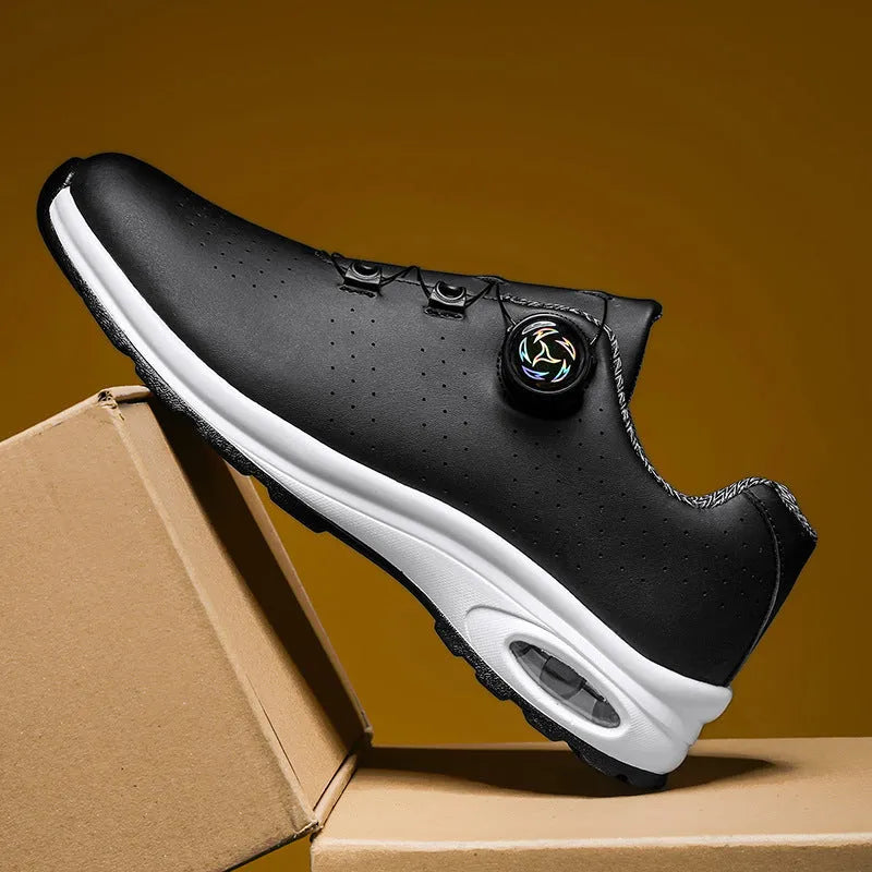 Black and white low-top tennis shoes with mesh upper and composite sole.
