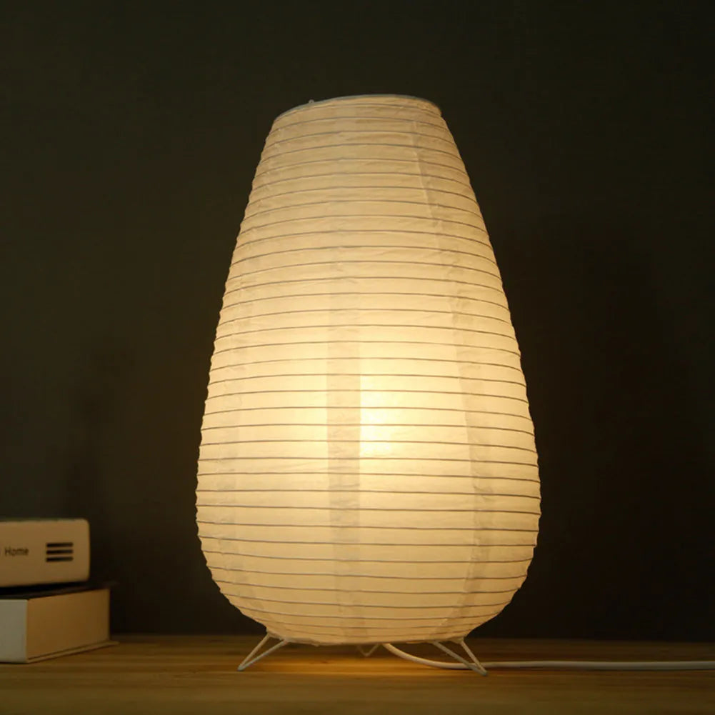 White rice paper table lamp with traditional handwork on bedside table