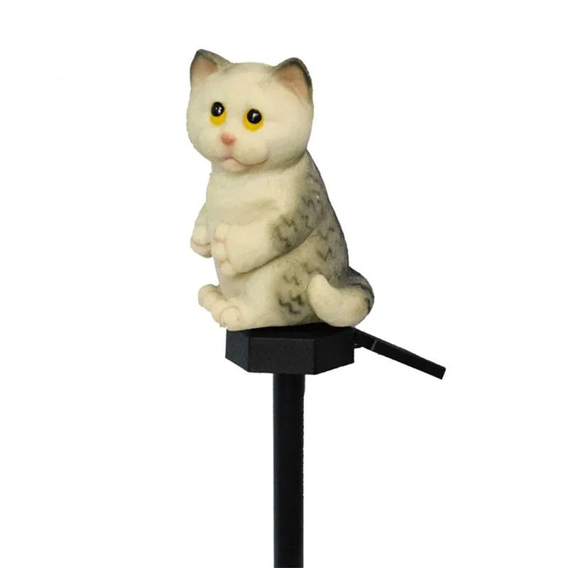 Brown cat-shaped solar lawn light with LED, placed in a garden.
