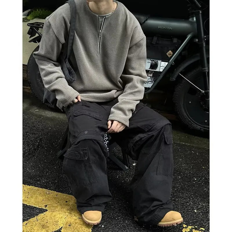 Men's solid grey loose-fit long sleeve pullover top on a hanger.