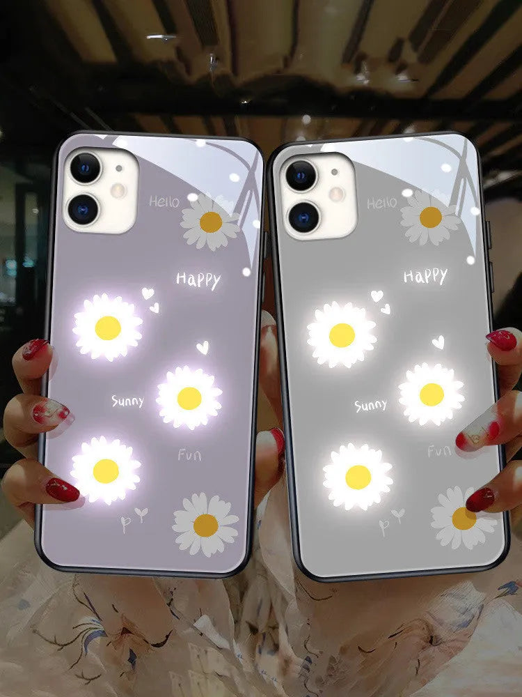 White luminous iPhone case with painted daisies and voice-activated colour-changing LED lights on a smartphone.