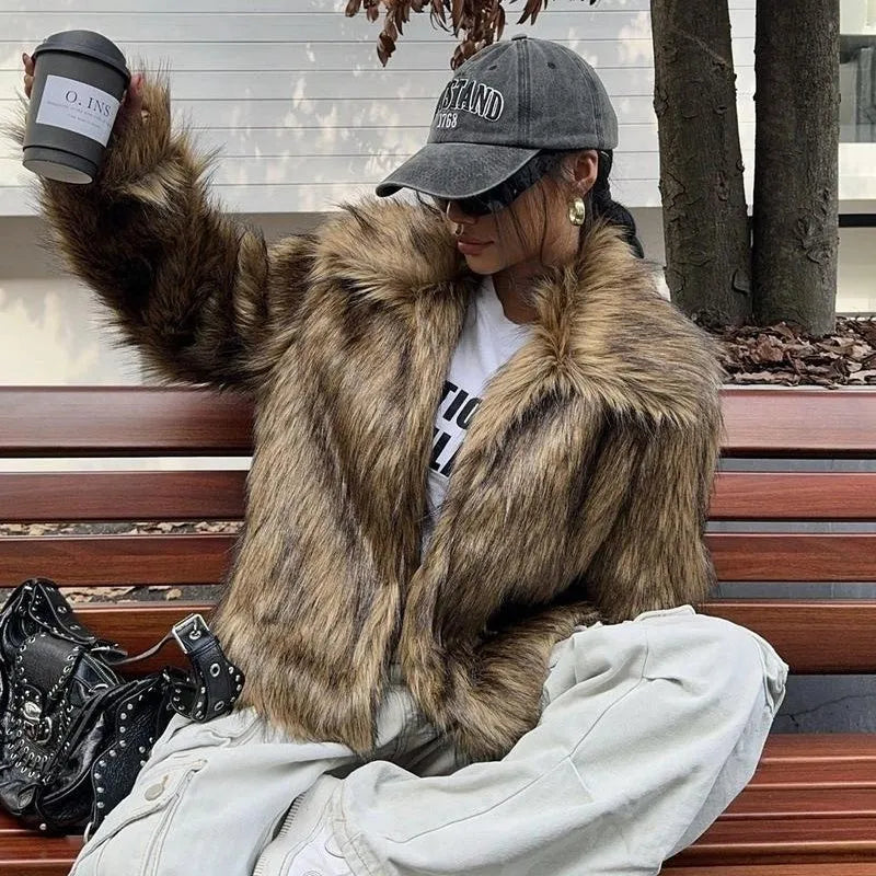 Women's short black and white artificial fur coat with a large fur collar, shown in a cute style pose.