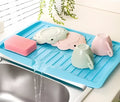 Kitchen dishes draining rack in blue, green, and white colour options on a countertop
