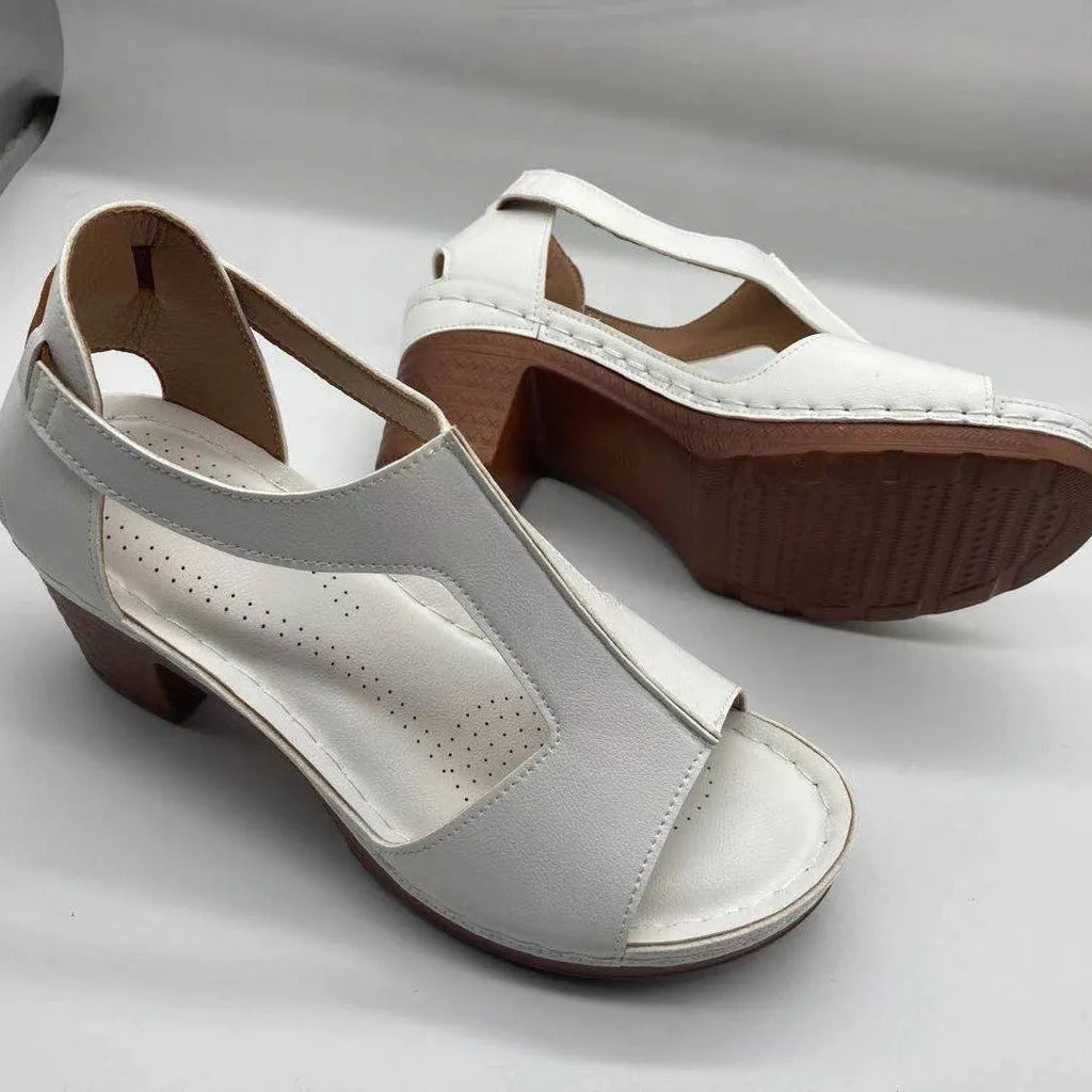 Women's low heel peep toe wedge sandals with a Roman style buckle strap in light brown.