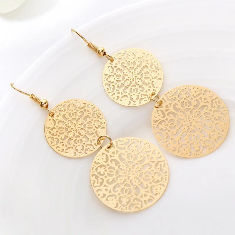 Women's gold round hollow dangle earrings made from zinc alloy, 4.5 by 8 cm, one pair
