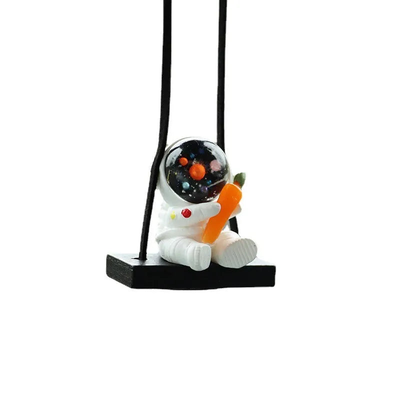 Cartoon style resin astronaut car pendant in five different colour and design variants.