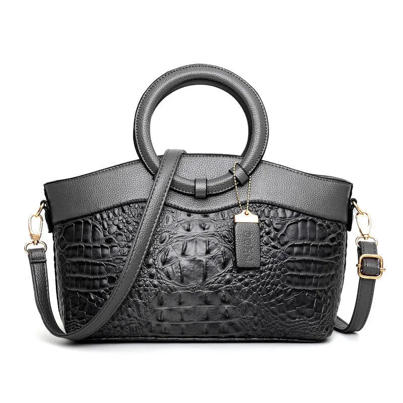 A casual fashion ladies' fabric handbag with a shoulder strap, shown in a choice of colours, featuring multiple zippered compartments.