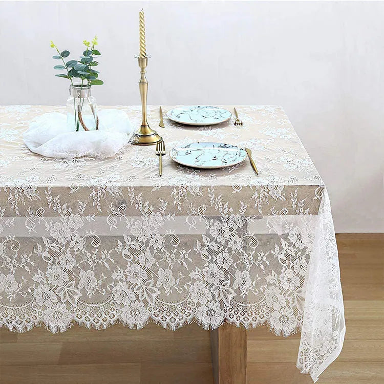 White embroidered lace tablecloth made from nylon yarn, 150x300cm, laid flat on a table with decorative pattern visible.