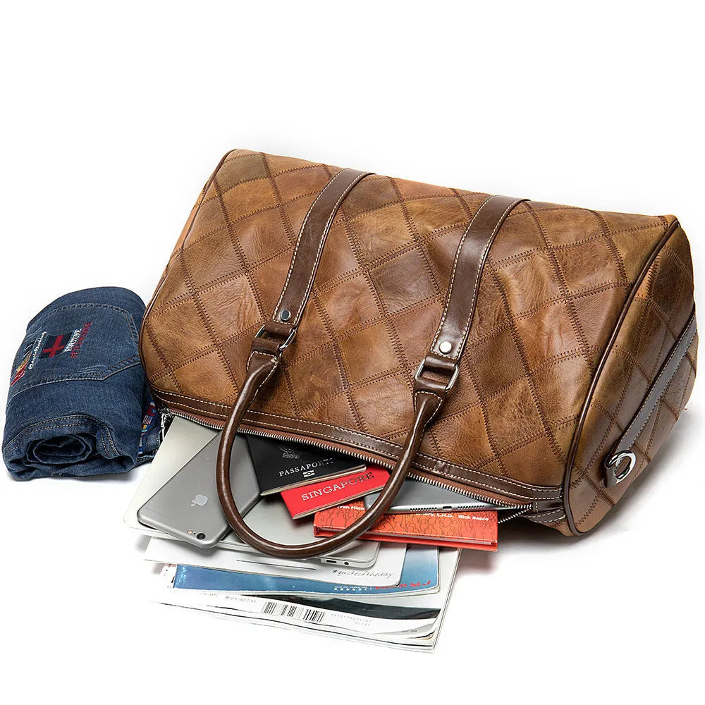 Vintage checked men's leather duffel bag with a single shoulder strap, shown in a light coffee colour.
