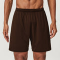 Man wearing dark brown double-layer quick-dry running shorts with a mid-waist fit.