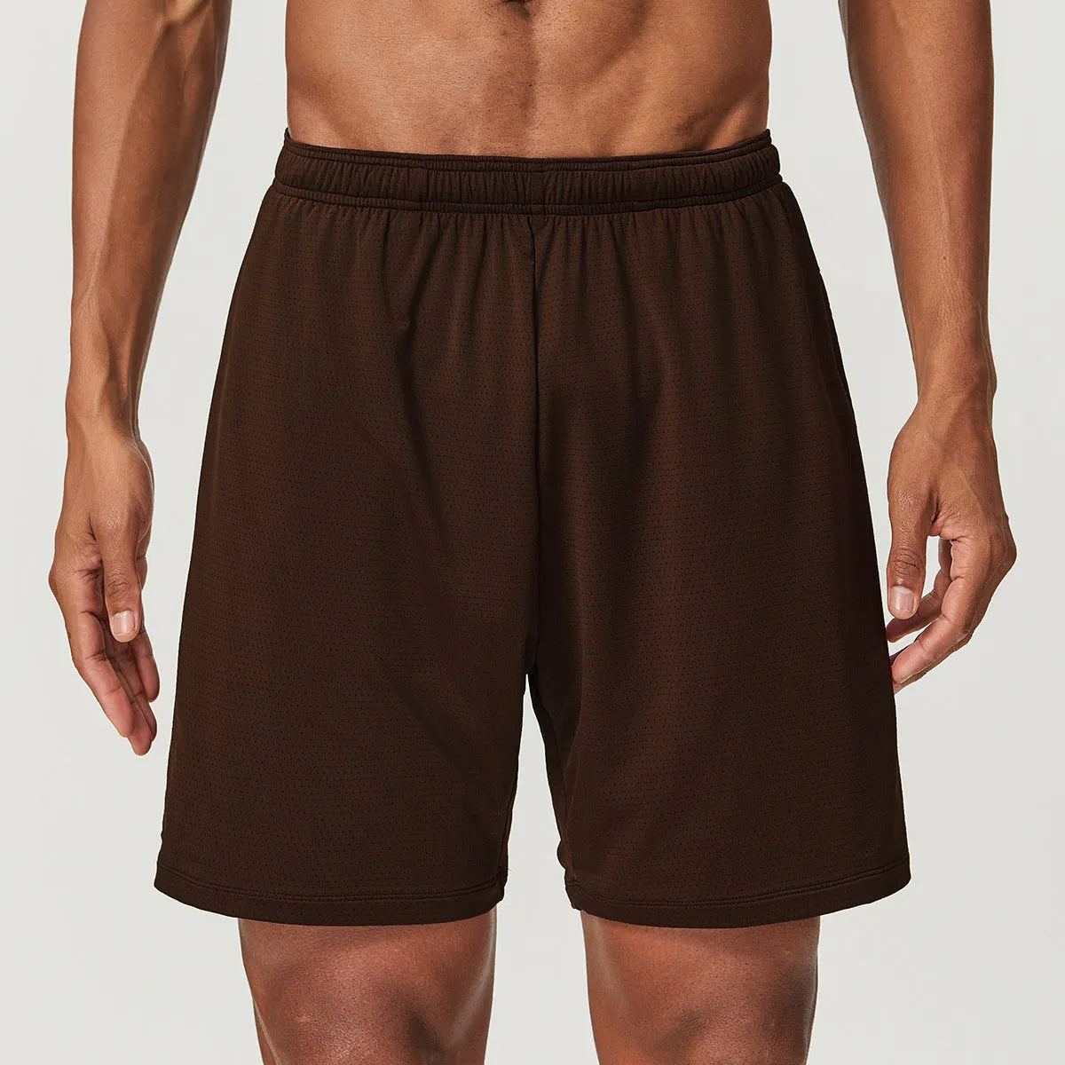 Man wearing dark brown double-layer quick-dry running shorts with a mid-waist fit.