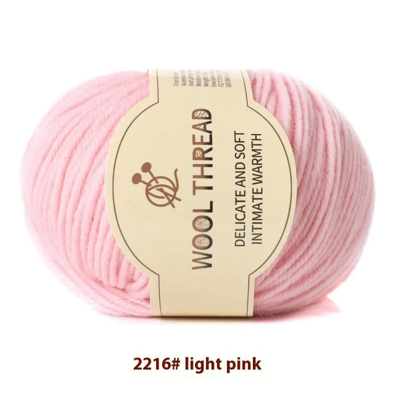 One roll of beige domestic wool hand-knitting yarn for size 10 needles next to knitting needles.