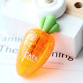 Orange carrot-shaped plastic pencil sharpener on a white background.