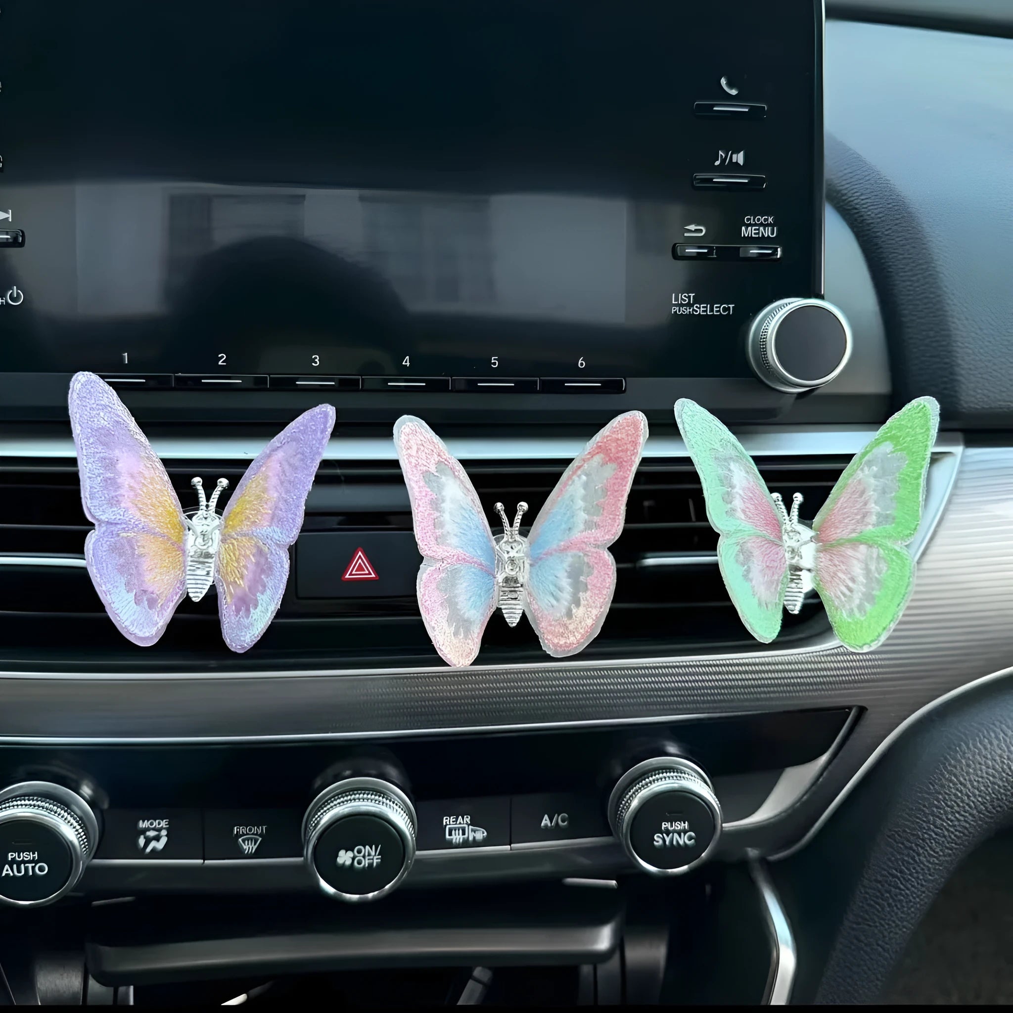 Fabric moving embroidery butterfly decoration for car centre console air vent in assorted colours.