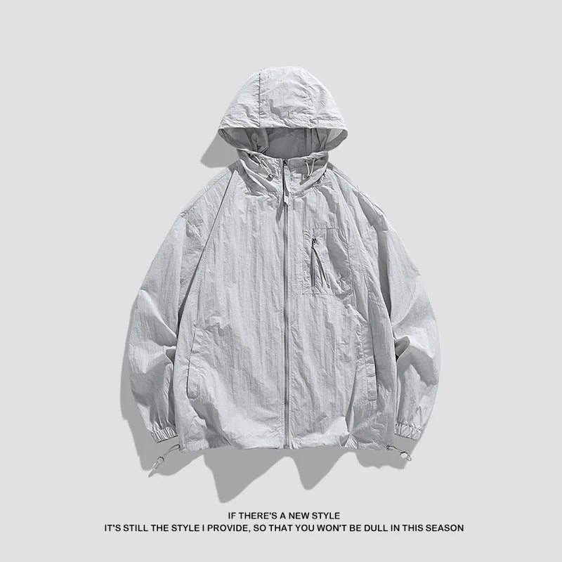 Lightweight beige hooded spandex sun protection jacket for men and women on a hanger.