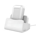 White minimalist headphone charging base on a desk or table