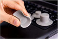 Four grey plastic laptop cooling pads, two large and two small, placed under a silver laptop on a wooden desk.
