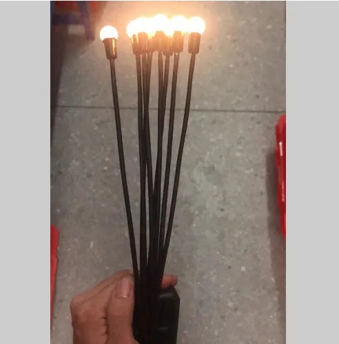 Solar-powered LED garden spike light with multiple firefly-like heads and a push-in pneumatic ground plug.
