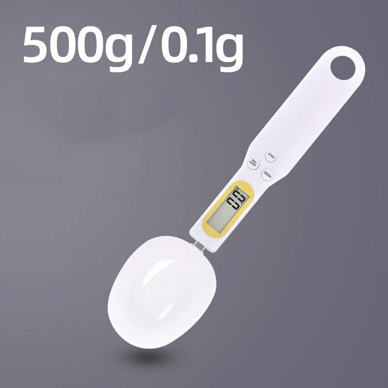 Black digital measuring spoon scale showing 0.0g display on LCD screen with 500g capacity