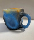 Purple resin coffee mug with handle showing crystal-like texture, 10cm tall.