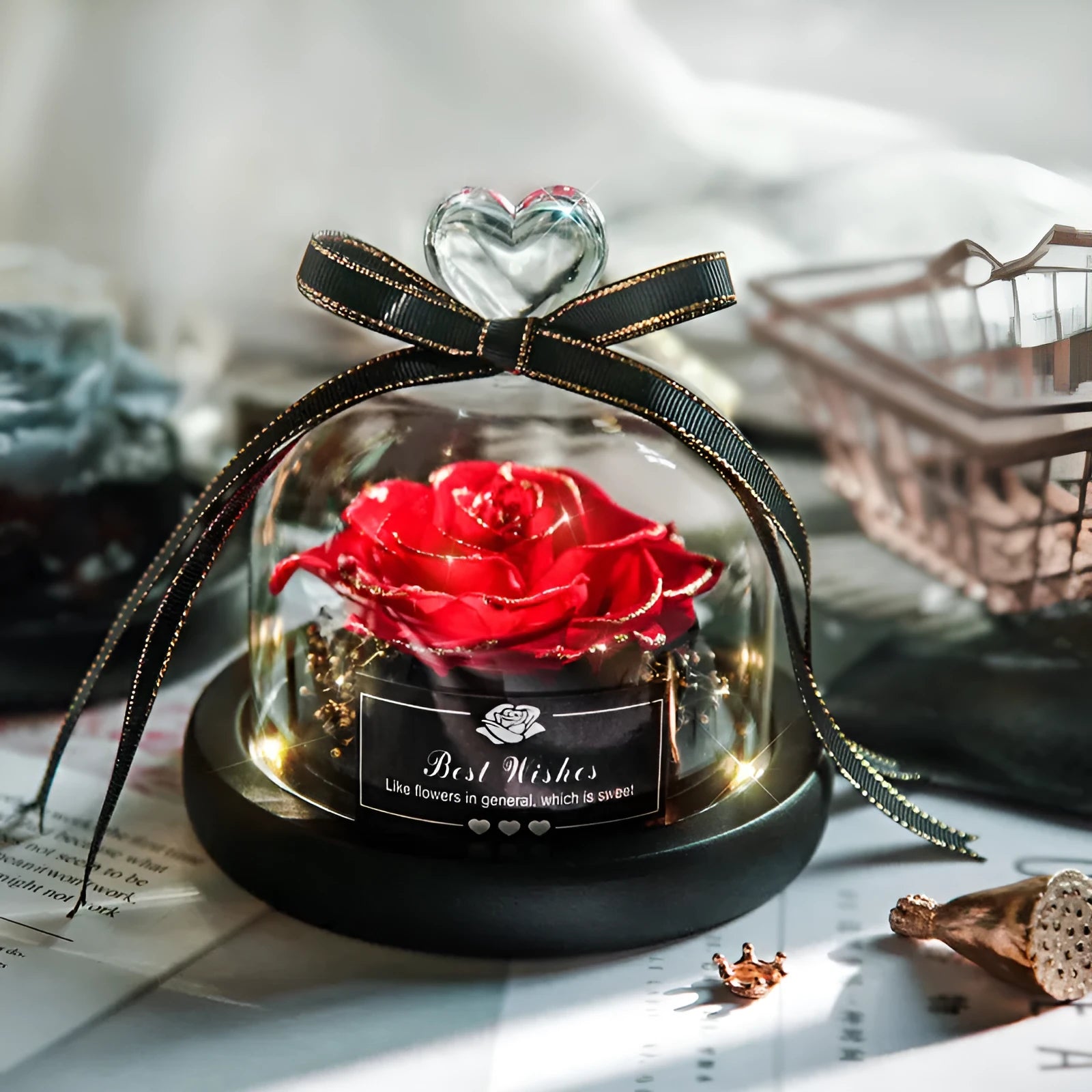 Glass dome containing a preserved red eternal rose illuminated by a soft LED light