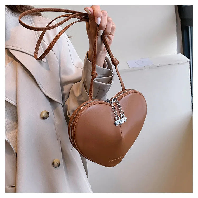 Heart shape women's shoulder bag in milky white PU with single crossbody strap and sewing line detail