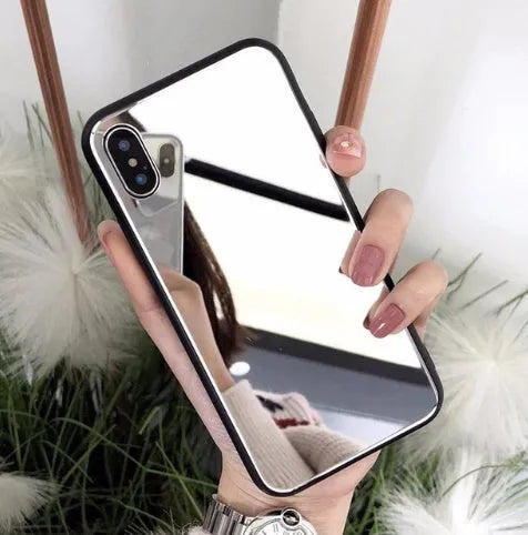 Black mirror back cover phone case for Apple iPhone X, 11, 12, 7, 8, and 6 models on a table.