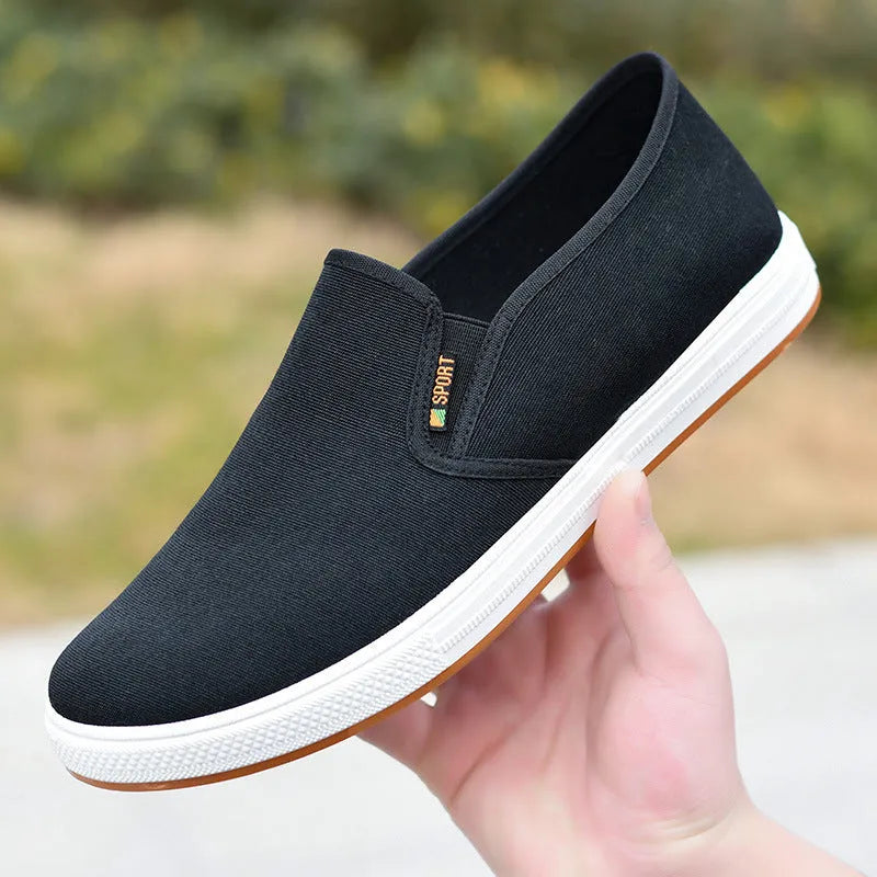 Men's low-top canvas trainers with slip-on design and round toe shape in black colour