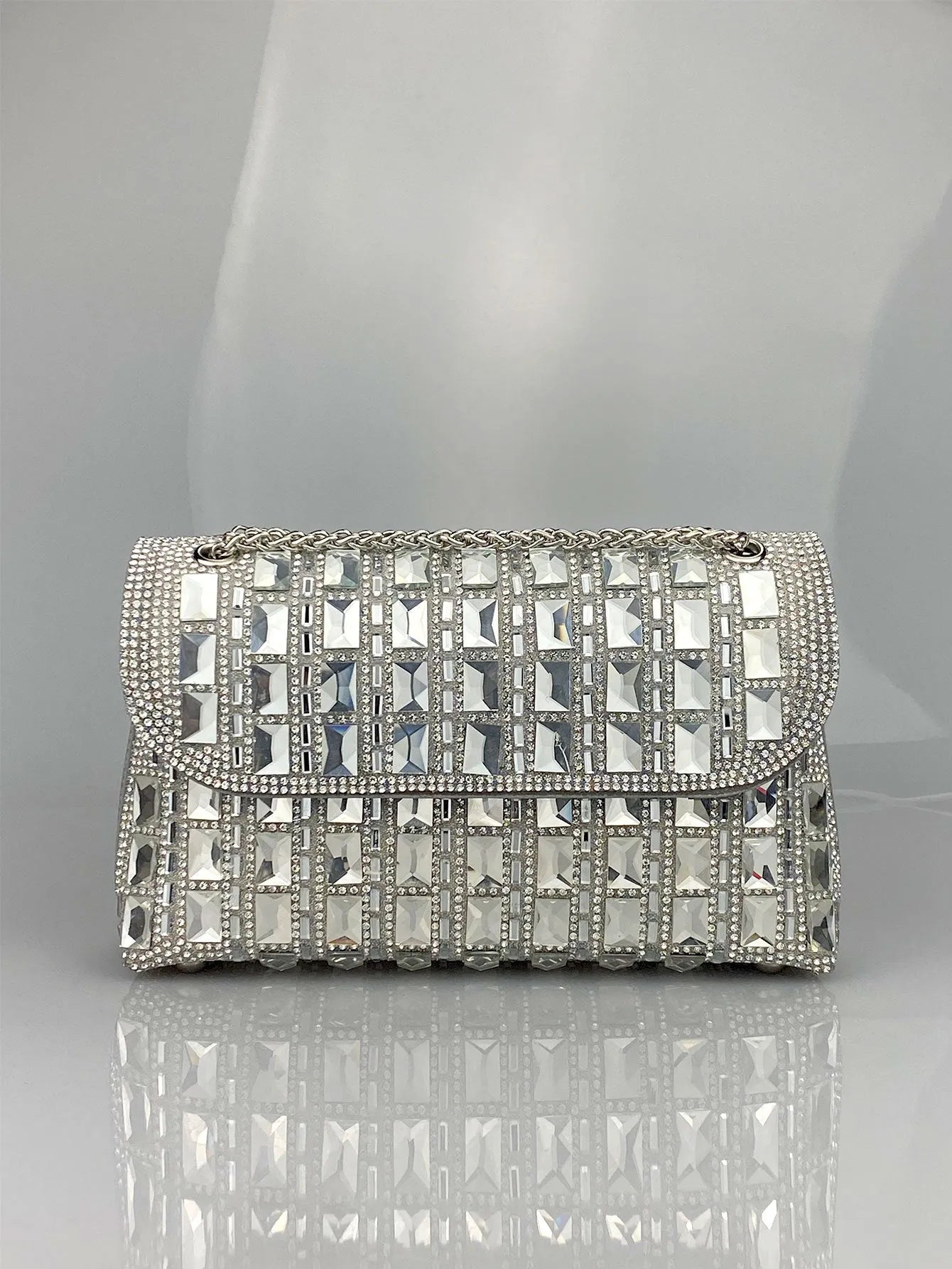 Silver rhinestone chain clutch purse with a horizontal square shape and open pocket.