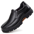 A pair of men's black slip-on business casual shoes made from cowhide leather with a rubber sole.