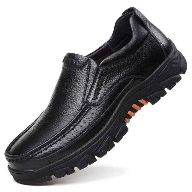 A pair of men's black slip-on business casual shoes made from cowhide leather with a rubber sole.