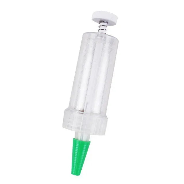 A white plastic mini garden seeder tool, 12cm long, for planting seeds in pots and trays.