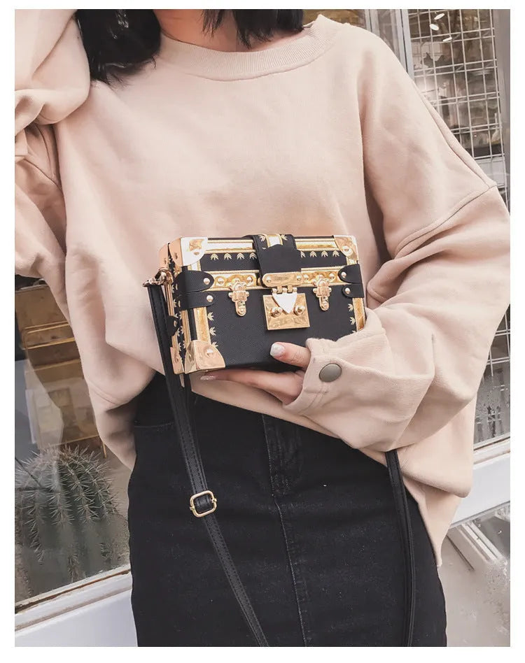Hard PU women's shoulder bag in black with flap closure, rivet detail, and adjustable strap.