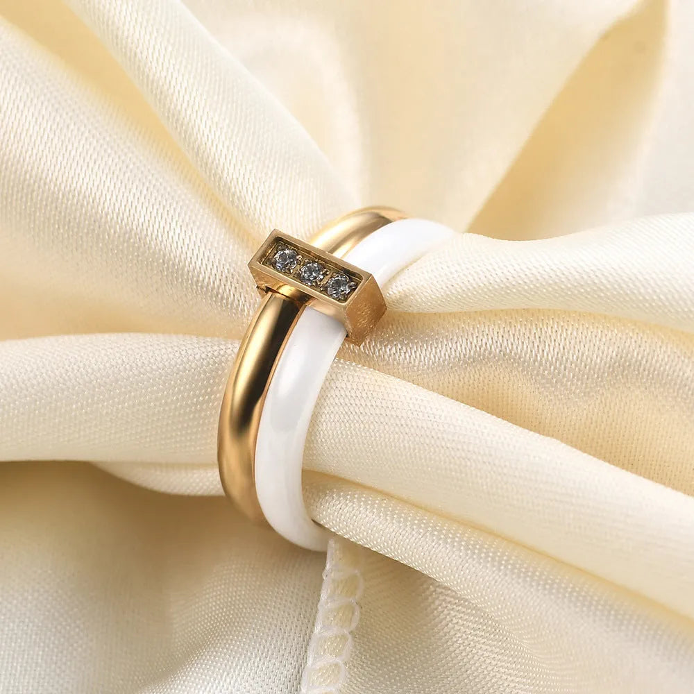 Glossy black ceramic women's ring with round inlaid detail on a 6mm wide geometric band.