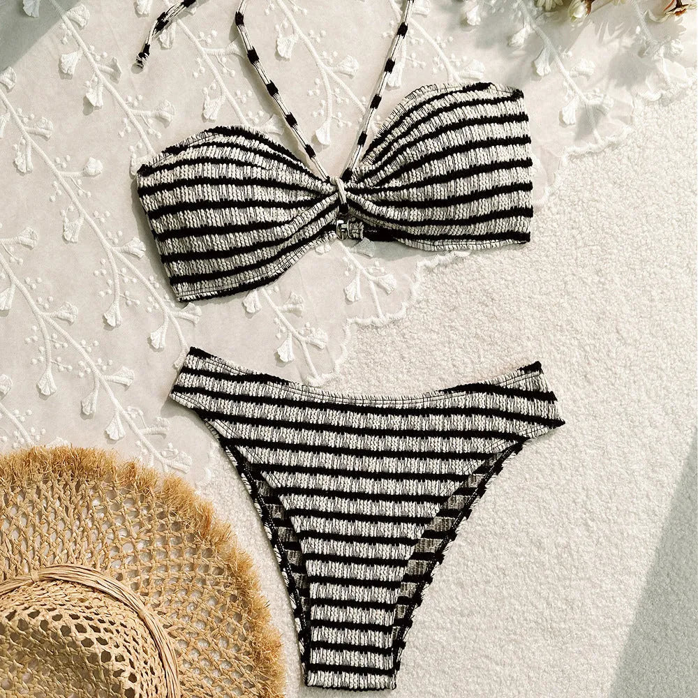 Women's pink and black striped bikini swimsuit with solid briefs.