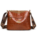 Brown cross body messenger bag with multiple compartments and sewing thread details on PU material