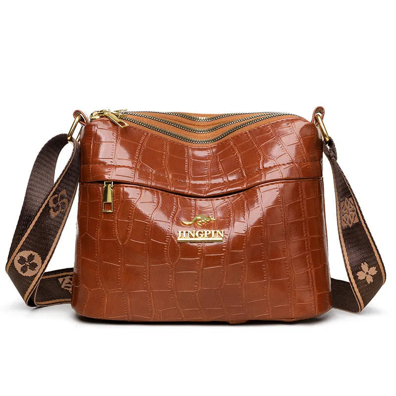 Brown cross body messenger bag with multiple compartments and sewing thread details on PU material
