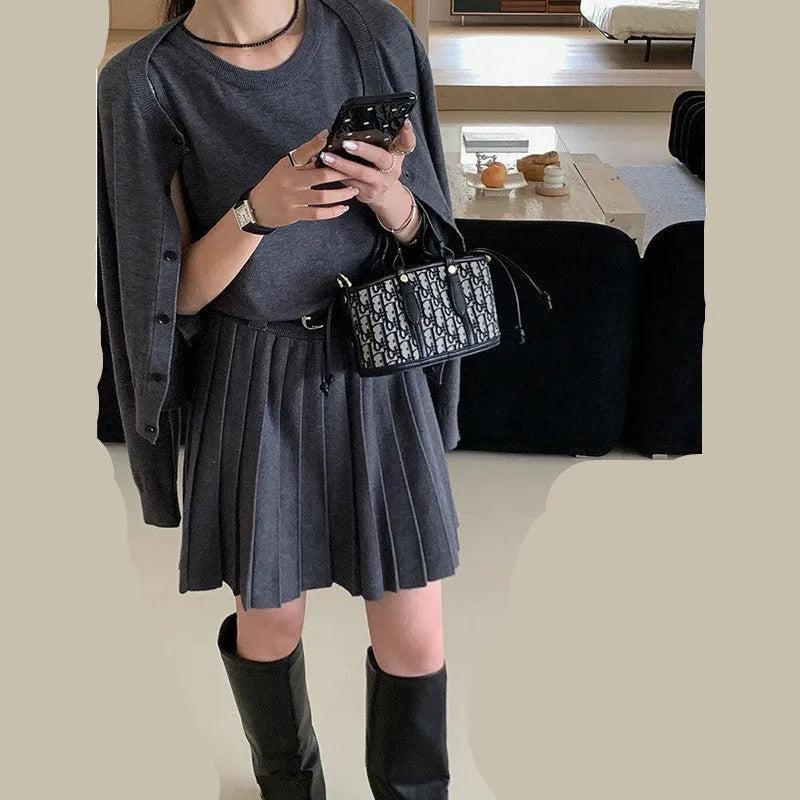 Women's grey Art Retro knitted set with 3D pattern, featuring a pleated midi skirt and long-sleeve cardigan.